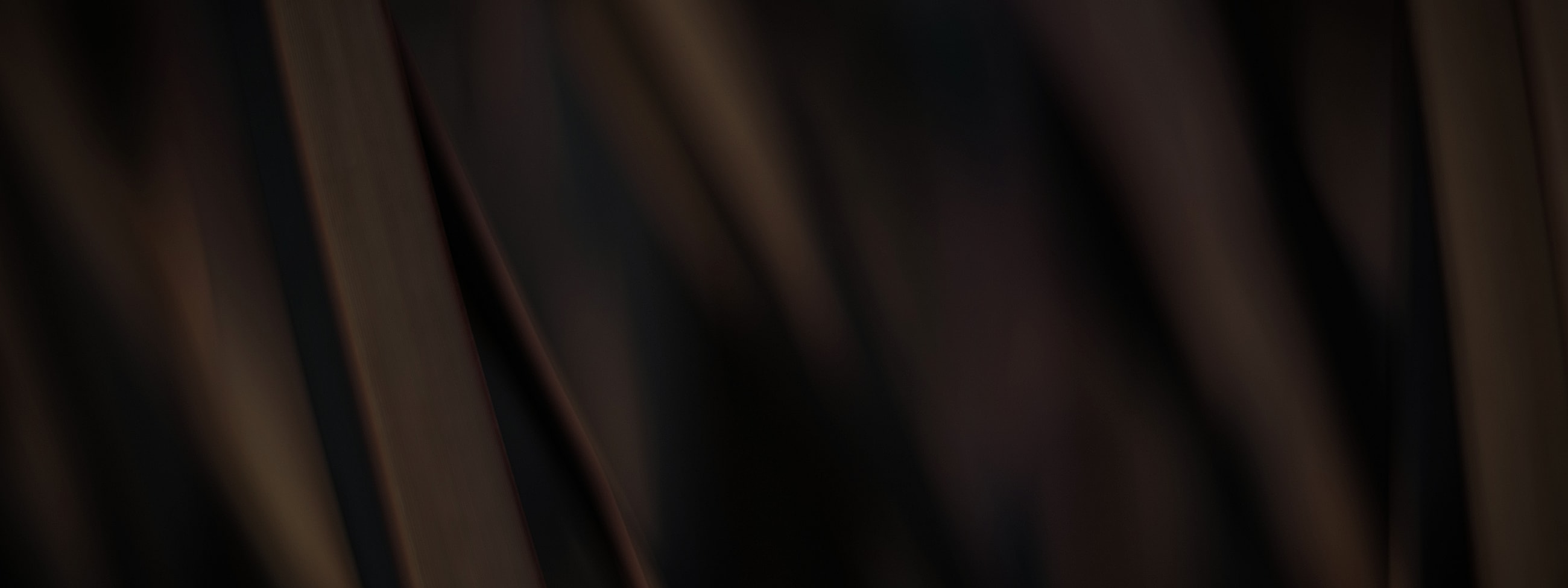 Abstract dark brown texture with soft lighting.