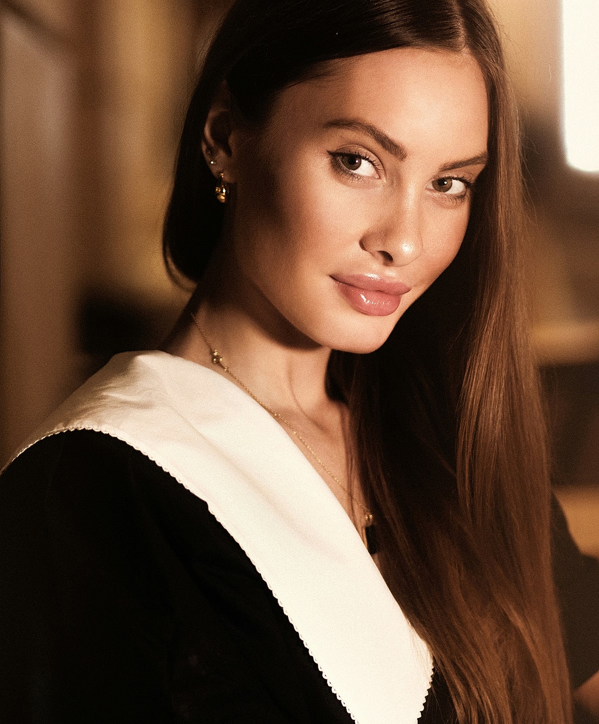 Woman with long hair and elegant attire.